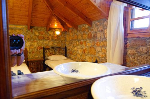a person taking a picture of a bathroom with a mirror at Kefalonian Luxury Villas in Kástron