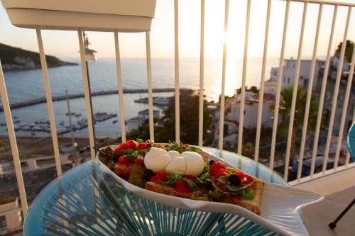 a plate of food on a table on a balcony at FICO D'INDIA in Peschici