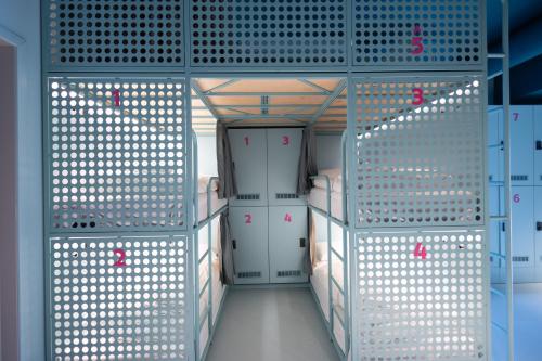 a locker room with a door and a corridor at Bunks at Rode in Oslo