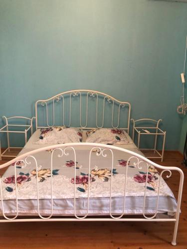 a bed in a bedroom with a blue wall at Anaklia boulevard house in Anaklia