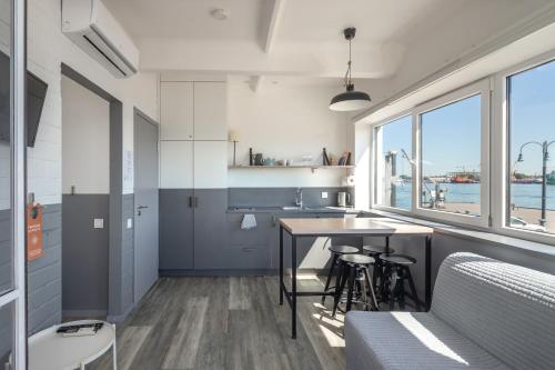 a kitchen with a table and some chairs in a room at Smiltynės Jachtklubas in Klaipėda