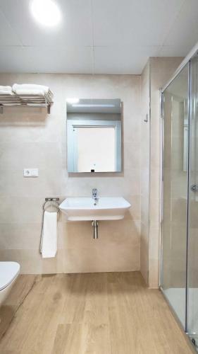 a bathroom with a sink and a shower at Terraza Suites Benidorm in Benidorm