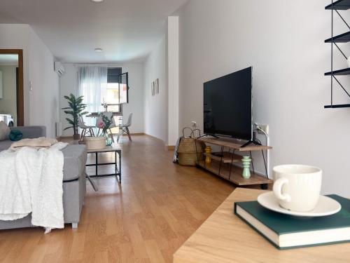 a living room with a couch and a flat screen tv at CerezasHomes3 in Jaraiz de la Vera