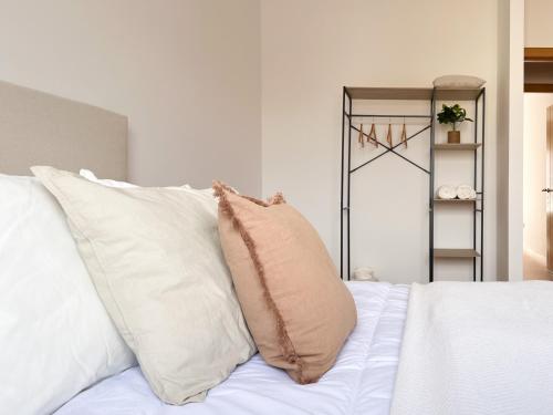 a pillow sitting on top of a bed with white pillows at CerezasHomes3 in Jaraiz de la Vera