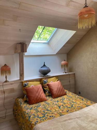 a bedroom with a bed in a room with a window at Maison de charme Vallée de la Rance DINAN LANVALLAY in Lanvallay
