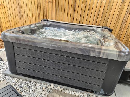 a hot tub sitting next to a fence at Nelson Parke in Yaroomba