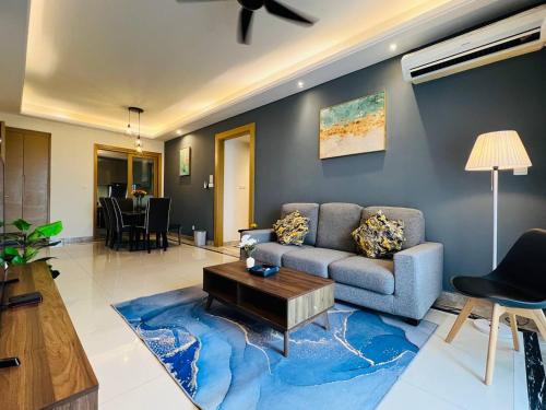 a living room with a couch and a blue rug at R&F PRINCESS COVE at ANJU in Johor Bahru