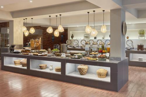 a display case in a kitchen with food at Holiday Inn & Suites Batangas LimaPark by IHG in Batangas City