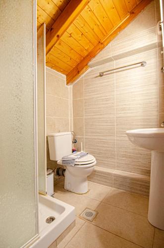 a bathroom with a toilet and a sink at Kefalonian Luxury Villas in Kástron