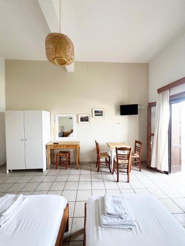 a room with a table and chairs and a dining room at Three Brothers in Mandrakion