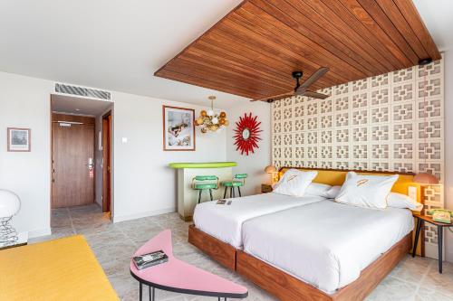 a bedroom with a large bed and a table at Los Felices Ibiza in San Antonio Bay