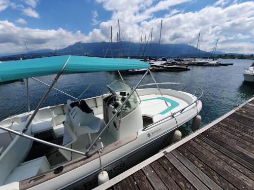 a boat is docked at a dock in the water at Le Lodge du Pichat in Sainte-Hélène-du-Lac
