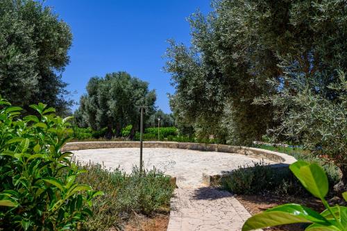a garden with a stone circle in the middle at Thyme Villa in Prínos
