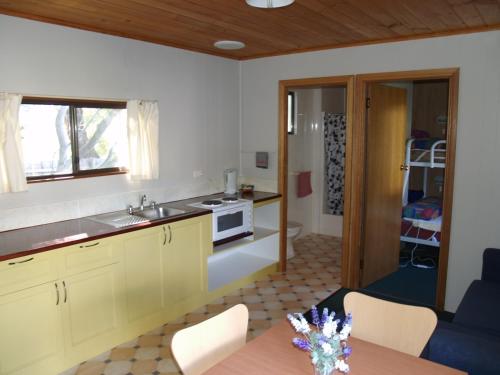 a kitchen with a sink and a table in a room at Launceston Holiday Park Legana in Legana