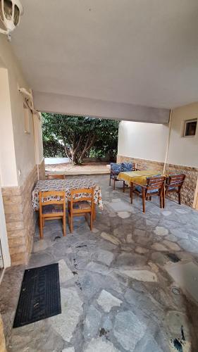 a patio with benches and tables and a table at LY apartment in Kallithea Halkidikis