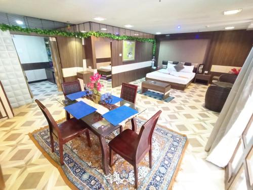 a living room with a table and chairs and a couch at The Piku's in Digha