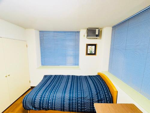 Postel nebo postele na pokoji v ubytování Sapporo Vacation Home B&B