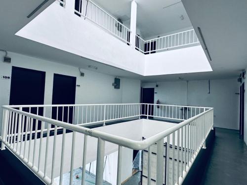 an empty room with a staircase in a building at Kuu Inn Hotel in Arau