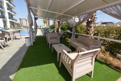 a row of chairs and tables under a canopy at Ethica Suite Luxury Houses in Aksu