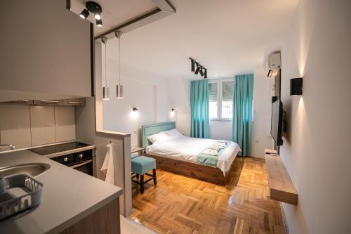 En eller flere senge i et værelse på L&D Apartments