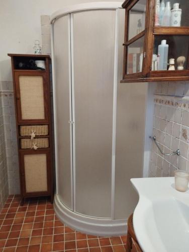 a stainless steel refrigerator in a kitchen with a counter at Appartamenti Villa Lina - La Sorella in Nisporto