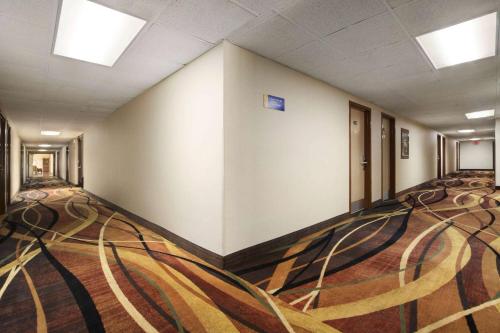 an empty hallway of a building with a carpet at Days Inn by Wyndham Rome Downtown in Rome