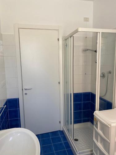 a bathroom with a shower with a glass door at Casa Vacanze Un passo dal Mare in Porto Recanati