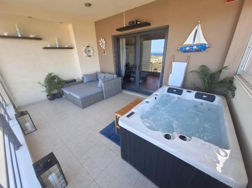 a large bath tub in a living room at Seaview apartment with jacuzzi and home cinema in Nea Makri