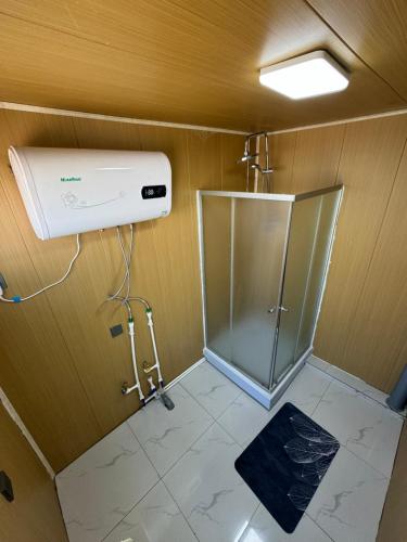 a bathroom with a shower and a heater at Ulgii Ger Camp in Ölgiy
