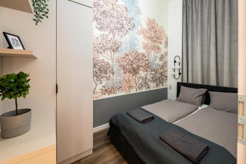 a bedroom with a bed and a potted plant at D52 Luxury Suite in Budapest