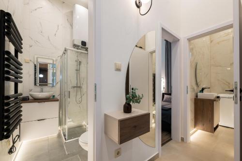 a bathroom with a sink and a toilet and a mirror at D52 Luxury Suite in Budapest