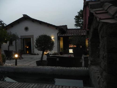 a backyard with a pool and a house at Tenuta del Duca Fiumicino Locanda e Hostaria Guest House in Fiumicino