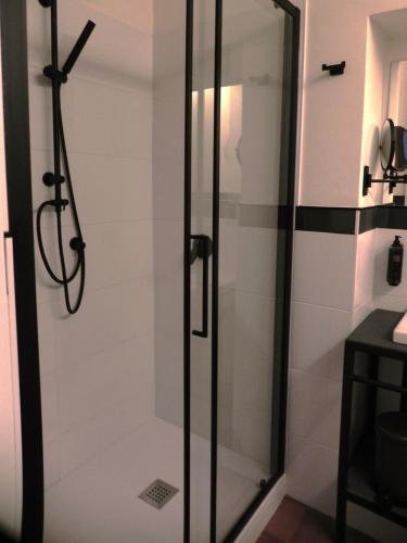 a shower with a glass door in a bathroom at Tenuta del Duca Fiumicino Locanda e Hostaria Guest House in Fiumicino