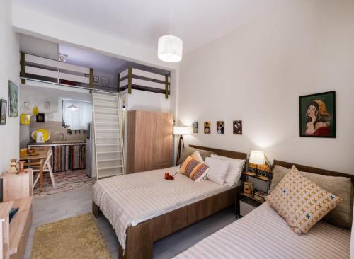 a bedroom with two beds and a living room at Οdyssey Apartments Lefkas Centrum in Lefkada