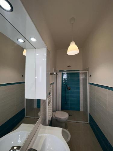 a bathroom with a sink and a toilet and a mirror at Donna Linda in Perdifumo