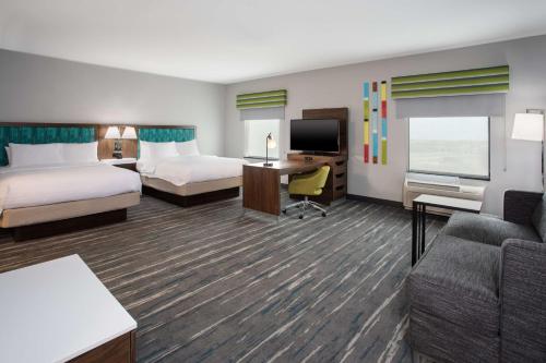 a hotel room with two beds and a couch at Hampton Inn & Suites Athens/Interstate 65 in Athens