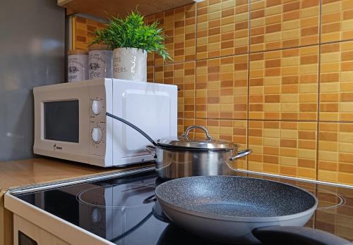 a pot sitting on top of a stove in a kitchen at - All-Around Skopje Apartments - Premium Hospitality - in Skopje