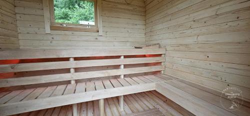 an empty wooden sauna with a window in it at Apartamenty Pod Uwalonym Dębem in Jeżów Sudecki