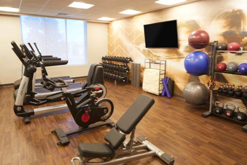 a gym with cardio equipment and a flat screen tv at Hyatt Place Las Vegas at Silverton Village in Las Vegas