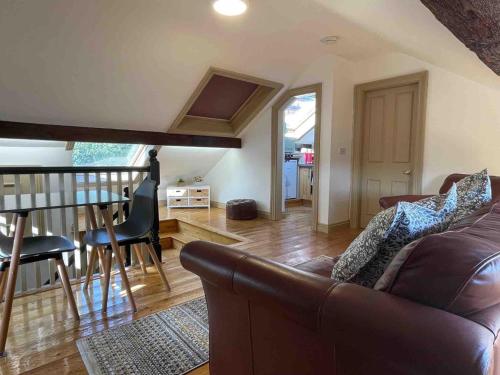 a living room with a couch and a table at Worcester City Centre self check-in cosy loft apartment in Henwick