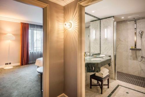 a bathroom with a sink and a shower at Hilton Brussels Grand Place in Brussels