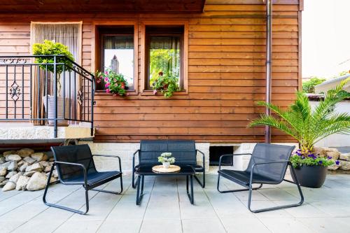 a patio with chairs and a table and a house at IRB Guest House Emona 4 in Nesebar
