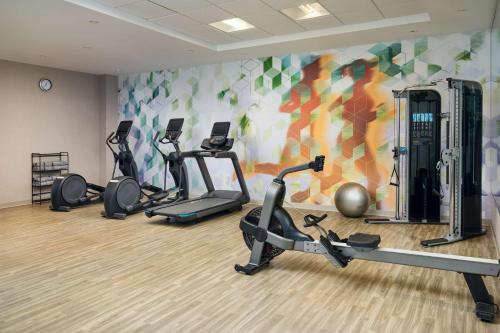 a gym with several exercise bikes in a room at Hyatt Place Melbourne Airport, Fl in Melbourne