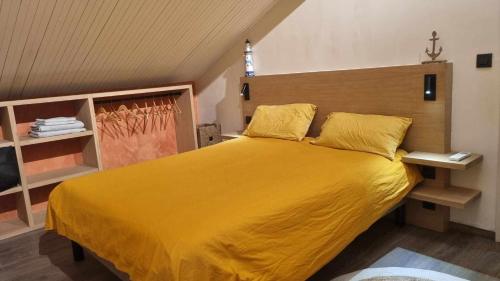 a bedroom with a large bed with yellow sheets at La Dolce Villa in Rapallo