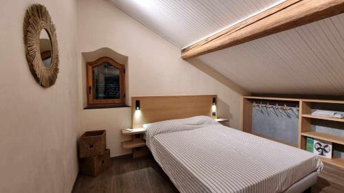 a bedroom with a bed and a mirror on the wall at La Dolce Villa in Rapallo