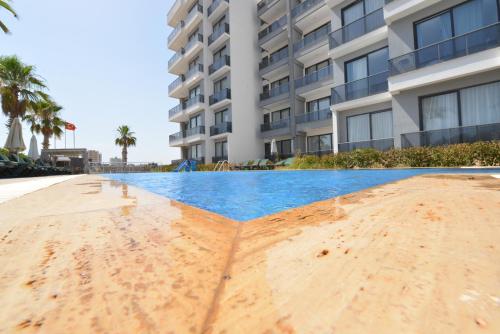 an empty swimming pool in front of a building at Ethica Suite Luxury Houses in Aksu