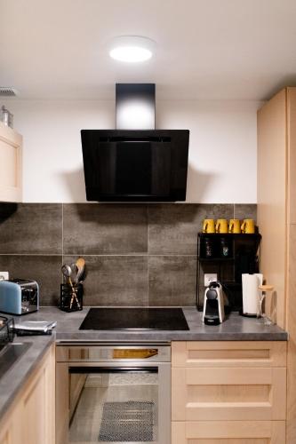 a kitchen with a stove top and a microwave at Appartement plain pied centre Eu in Eu