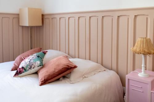 a bed with two pillows on top of it at Appartement plain pied centre Eu in Eu