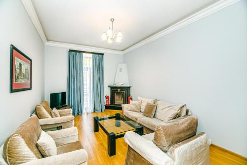 a living room with two couches and a table at Azneft Royal Suite Apartment Sea View in Baku
