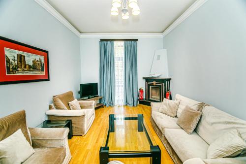 a living room with a couch and a coffee table at Azneft Royal Suite Apartment Sea View in Baku